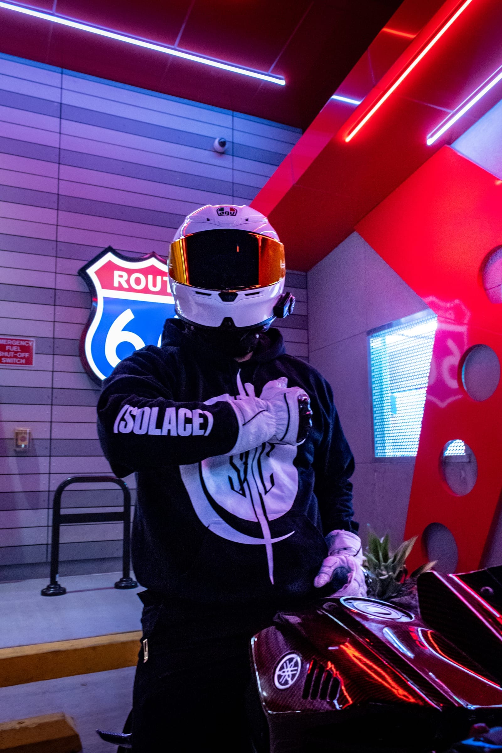 Rider in a white helmet showing the (SOLACE) sleeve of his hoodie