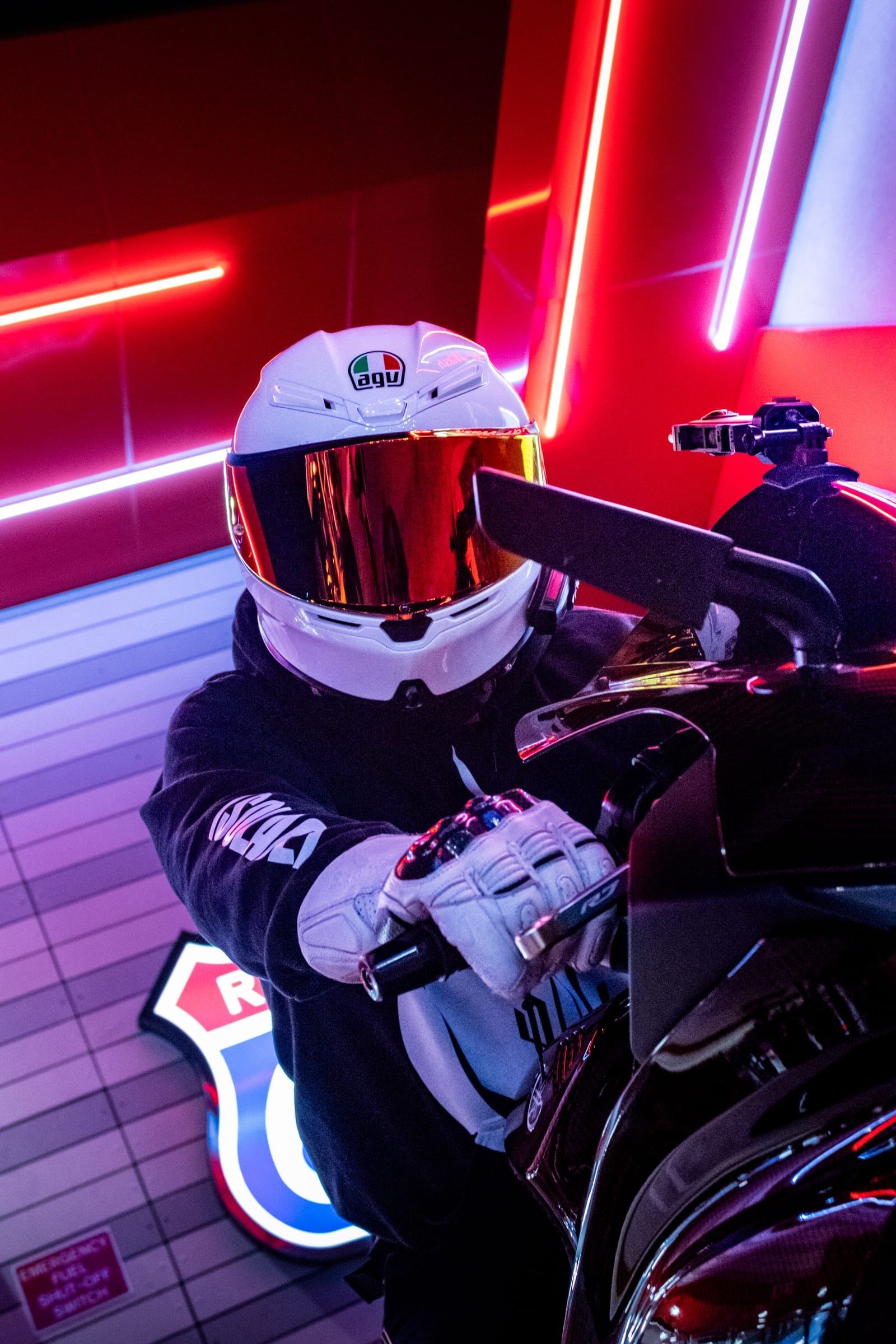 Papa Squid in a white helmet under red neon