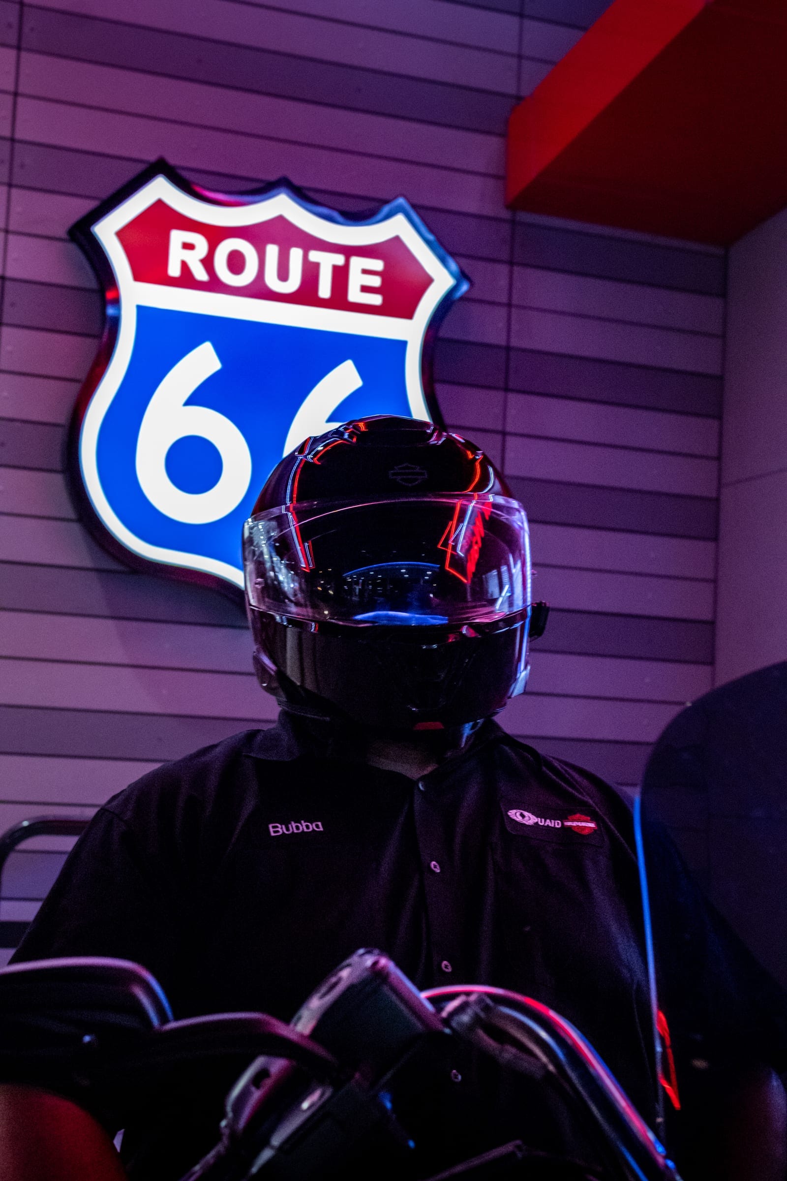 Ramon seated on his Harley under neon