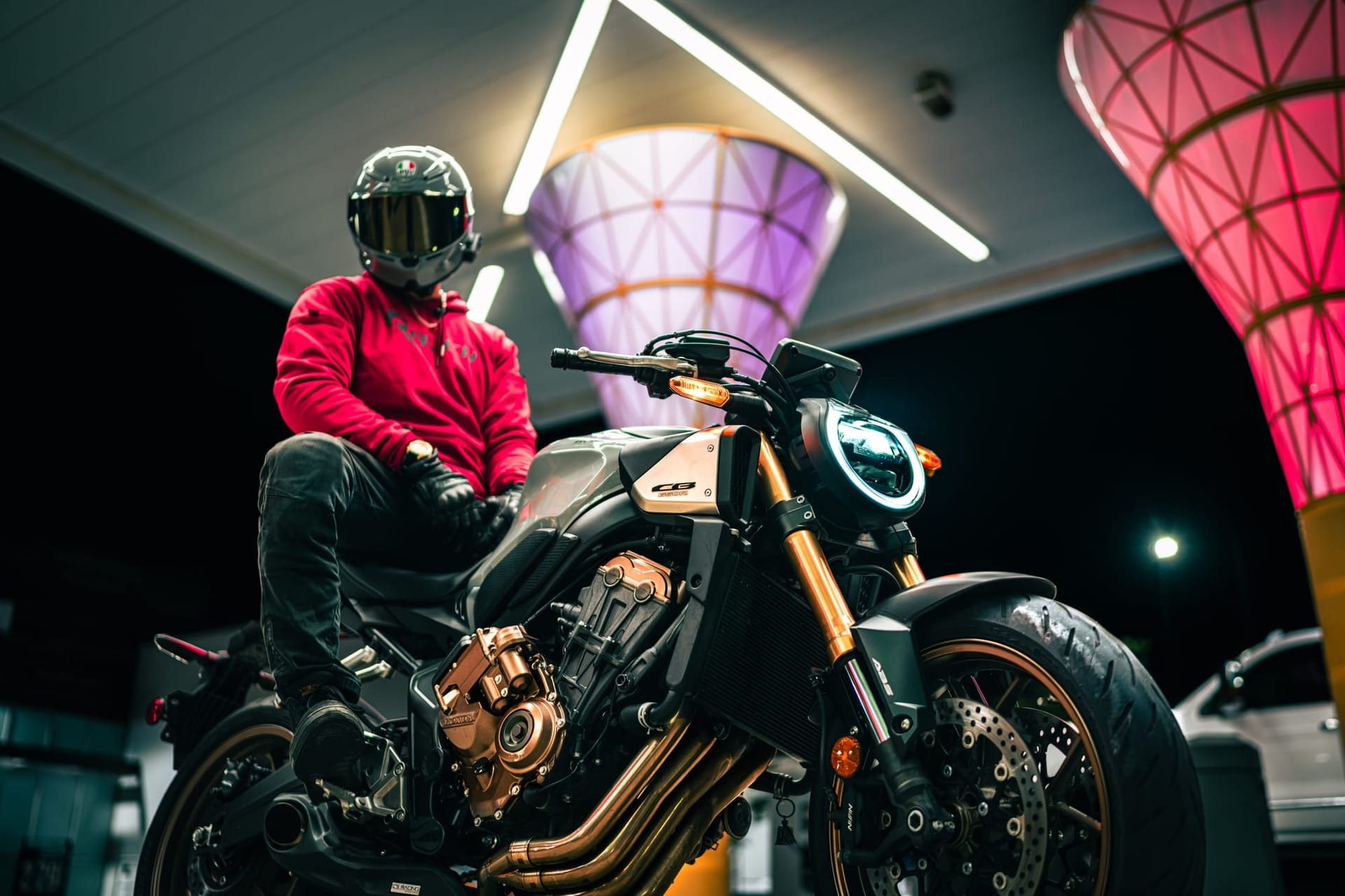 Rider on a Honda CB650R between the canopy cones