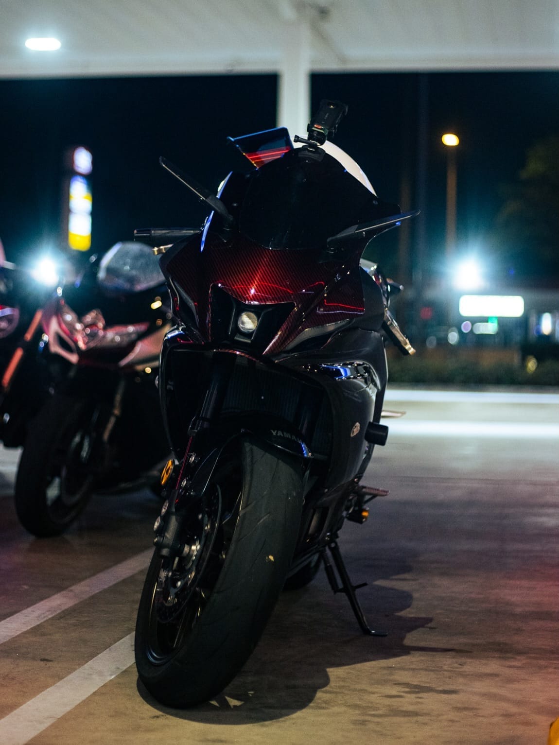 A sportbike parked under the canopy lights