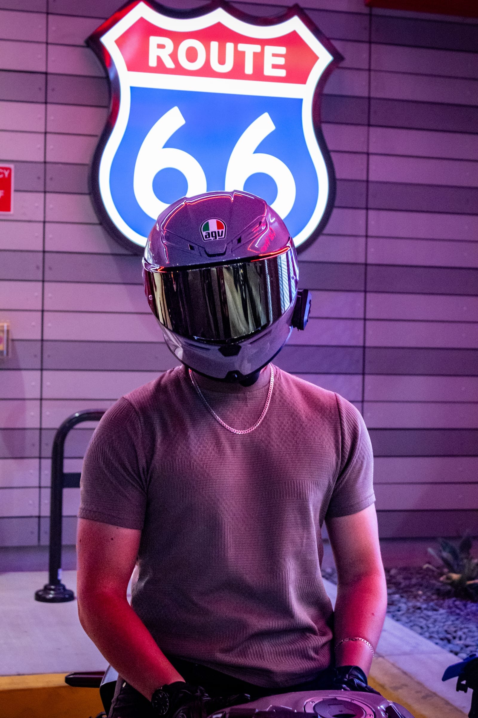 Rider in a mirrored-visor helmet under the Route 66 sign