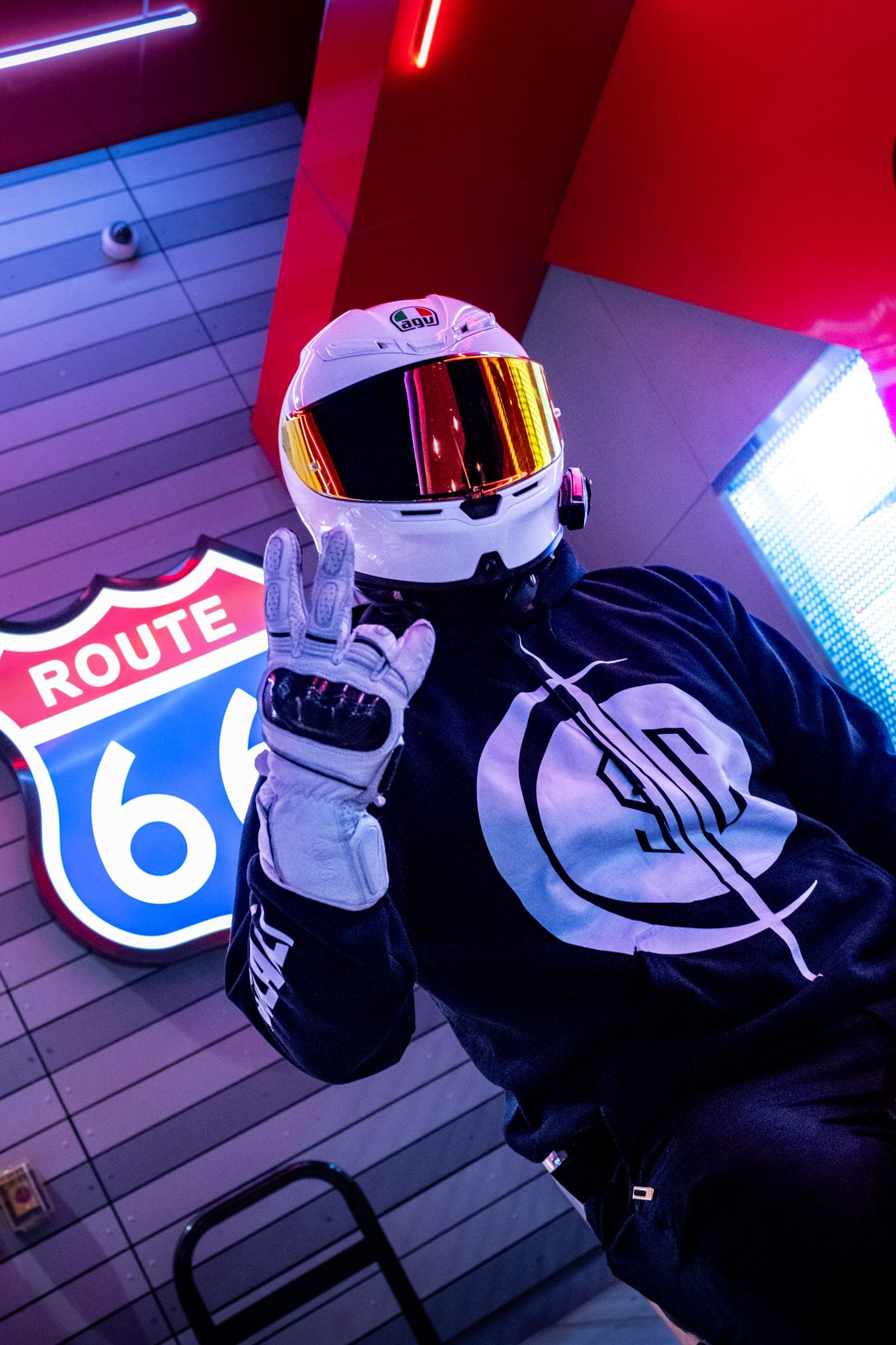 Rider wearing the Solace hoodie under neon