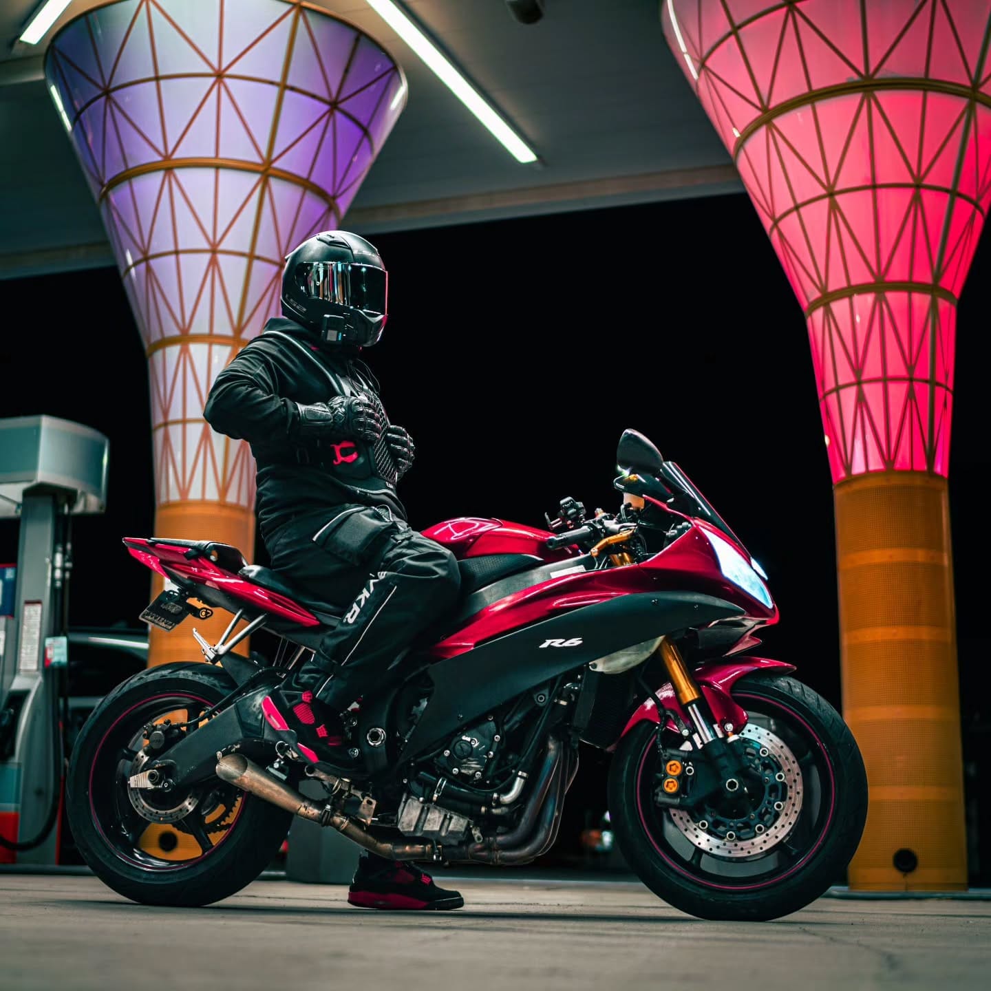 Rider on a red sportbike under the canopy cones